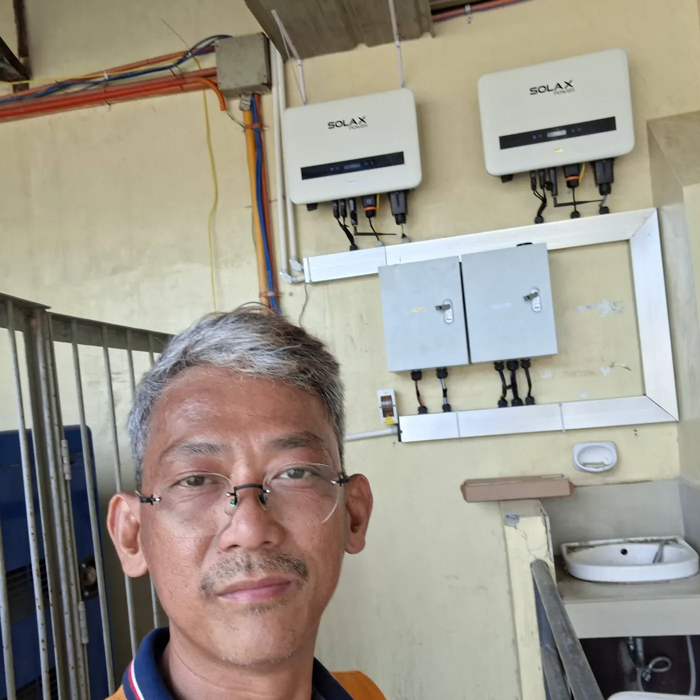 Two wall-mounted SolaX solar units with electrical enclosures